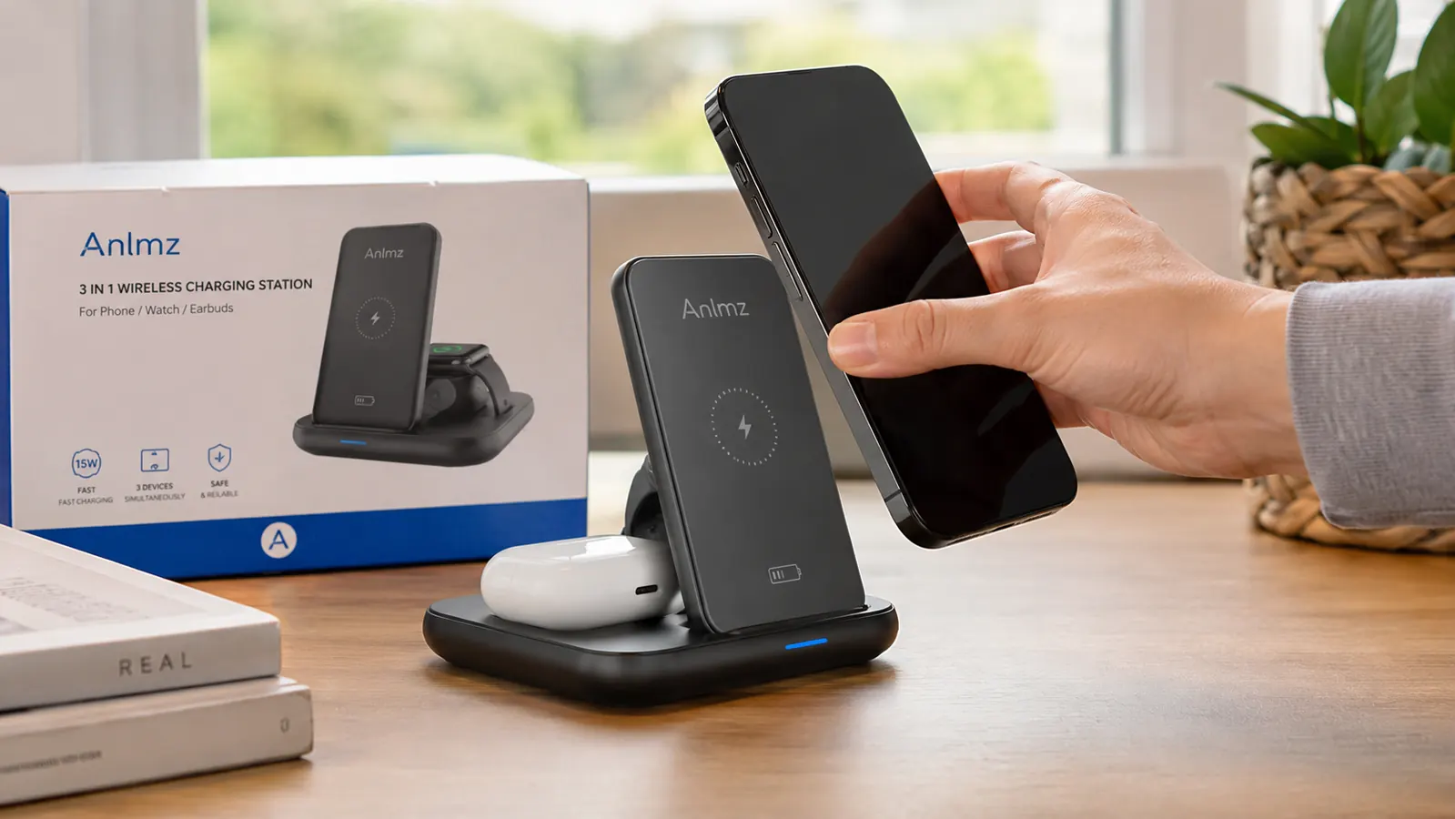 Hand setting an iPhone onto the upright phone dock of the Anlmz charging station on a desk