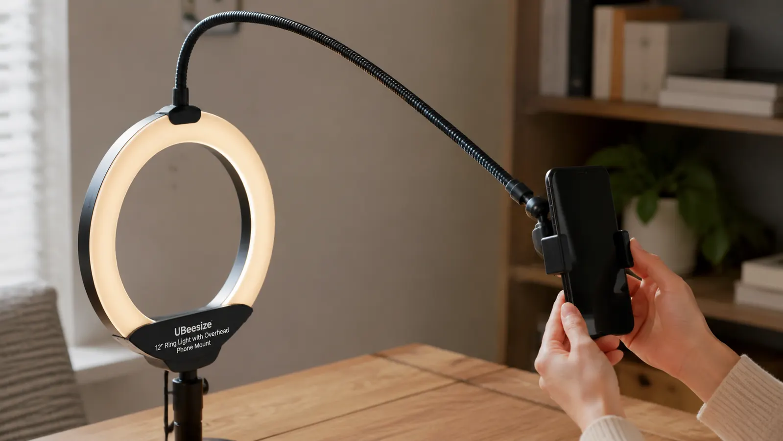 Overhead phone mount arm on the ring light drooping slightly under the weight of a phone